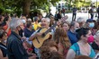 German musician Henning Zierock plays Miki's songs with his guitar as he waits to pay trib...