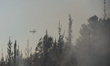 (150724) -- BEIT SHEMESH, July 24, 2015 () -- An aircraft flies over the heavy smoke cause...
