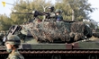 Taiwanese soldiers are seen holding grenade launchers and machine guns and driving tanks,...