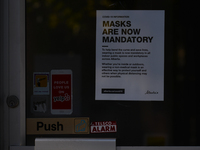 Sign 'Masks Are Now Mandatory' seen on a entrance door to a shop in Edmonton.
Alberta has declared a state of public health emergency and wi...