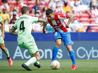 Angel Correa of Atletico de Madrid in action with Inigo Martinez of Athletic Club during the La Liga match between Atletico de Madrid and At...