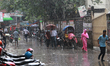 People walk during a rainfall in Dhaka, Bangladesh on September 21, 2021.  