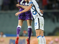 Nicolas Gonzalez of ACF Fiorentina and Milan Skriniar of FC Internazionale jump for the ball during the Serie A match between ACF Fiorentina...