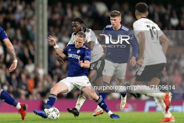 Joshua Onomah of Fulham and Adam Forshaw of Leeds United battle for the ball during the Carabao Cup match between Fulham and Leeds United at...
