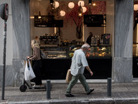 People seen walking front of a cafe in the center of Athens, Greece on September 22, 2021. (