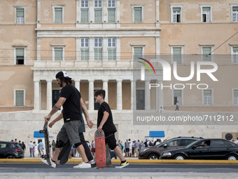 People with skateboard at Syntagma square in the center of Athens, Greece on September 22, 2021. (