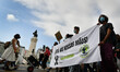 Demonstrators hold a banner during a march in favor of ecology and against government poli...