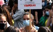 A demonstrator holds a protest sign during the march for the environment. Lisbon, Septembe...