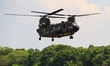 A Chinook Helicopter flies over a military camp, as part of a rehearsal for the flyby perf...