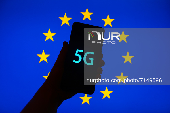 5G sign is seen on the smartphone screen with European Union flag in the background in this  illustration photo taken in Krakow, Poland on S...