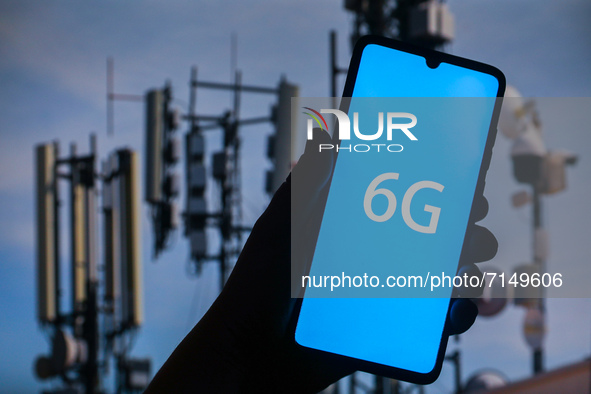 6G sign is seen on the smartphone screen with telecommunication towers in the background in this  illustration photo taken in Krakow, Poland...