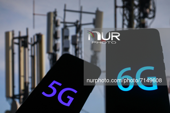 5G and 6G signs are seen on the smartphone screen with telecommunication towers in the background in this  illustration photo taken in Krako...