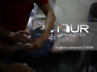 A nurse gives an Hepatitis A vaccines, to a child in the vaccine's center belongs to the Syrian Arab Red Crescent - Douma branch,
Picture i...