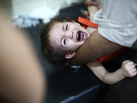 A child reacts after get her vaccines in the vaccine's center belongs to the Syrian Arab Red Crescent - Douma branch,
Picture is taken in A...