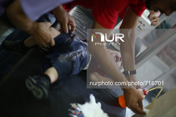 A child getting ready to take his vaccine in the vaccine's center belongs to the Syrian Arab Red Crescent - Douma branch
Picture is taken i...