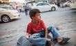 A boy with a scale offers his service to customers in the streets of Dohuk / Summer 2013....