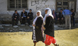 Women walk on the streets of Ribnovo during traditional circumcision ritual in  Rhodope Mo...