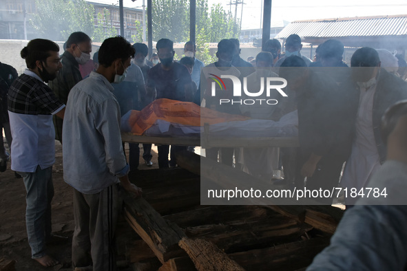 The family along with local people prepare to cremate the dead body of slain chemist ML Bindroo who was killed by unknown gunmen in Srinagar...