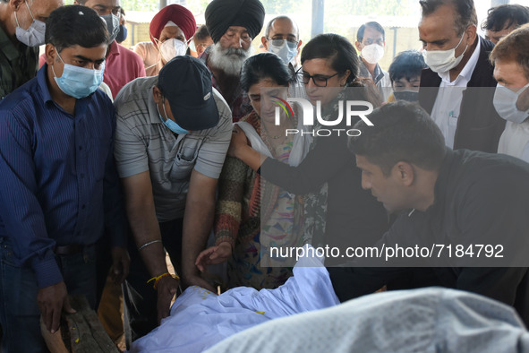 The family along with local people prepare to cremate the dead body of slain chemist ML Bindroo who was killed by unknown gunmen in Srinagar...