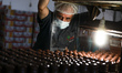 Palestinian workers prepare the vanilla candy known as "crimbo or Ras El-abed" in the swee...