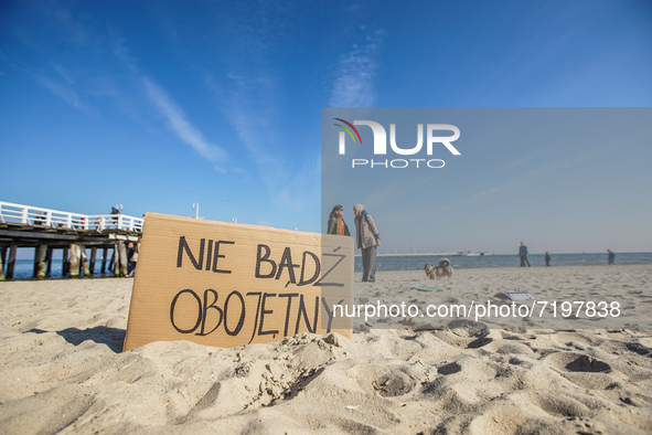 Protesters in front of 'do not be indifferent' banner are seen in Sopot, Poland on 10 October 2021  People protest under the slogan: Don't t...