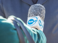 Reporter holding a microphone with TVN 24 TV station logo is seen in Sopot, Poland on 10 October 2021  People protest under the slogan: Don'...