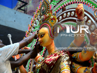 An artist gives final touch to the idol of Hindu Goddess Durga during Durga puja festival in Dhaka, Bangladesh, on October 10, 2021 (