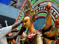 An artist gives final touch to the idol of Hindu Goddess Durga during Durga puja festival in Dhaka, Bangladesh, on October 10, 2021 (
