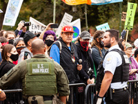 US Park Police guard a barricade while Native American activists and allies await arrest during a protest at the White House against the con...