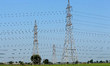 High-tension power lines are pictured in a field, on the outskirts of New Delhi, India on...