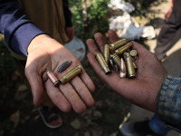 Kashmiri kids show bullet cartridges outside the encounter site in Feripora village south of Srinagar, Indian Administered Kashmir on 12 Oct...