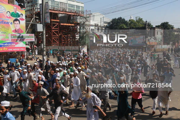 Muslims devotees march during a protest over demeaning of the Holy Quran in Cumilla, in Dhaka, Bangladesh on October 15, 2021.  