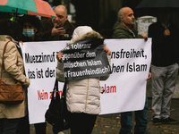 protesters hold banners " Tolerance towards political Islam is misogynistic " during the protest over city decision allowing broadcasting th...