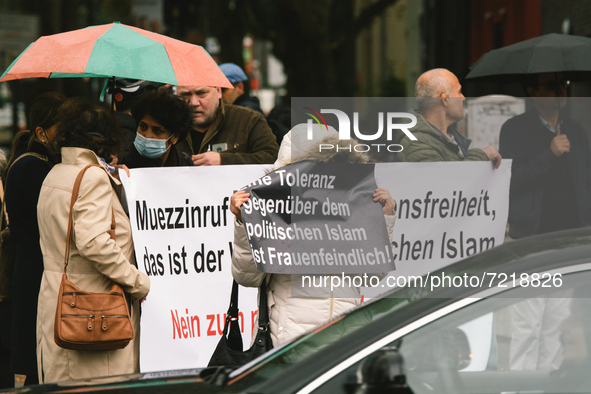 protesters hold banners " Tolerance towards political Islam is misogynistic " during the protest over city decision allowing broadcasting th...
