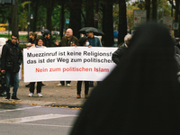 protesters hold banners " the calling to prayer is not freedom of religion" during the protest over city decision allowing broadcasting the...