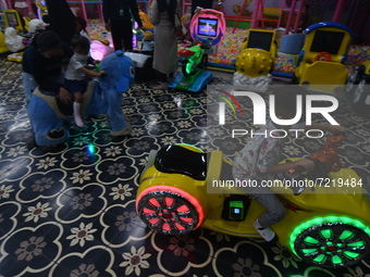 Children play in one of the games that was re-opened at a shopping center in Palu, Central Sulawesi Province, Indonesia, Friday (15/10/2021)...