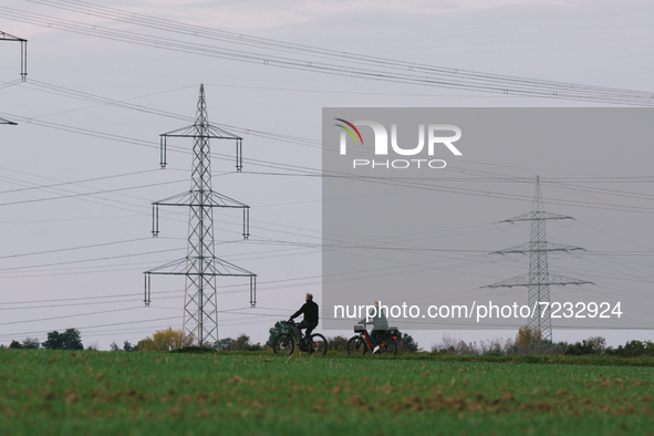 two bicycles are seen in front of two Electricity transmission pylons in Wesseling, Germany on Oct 17, 2021 