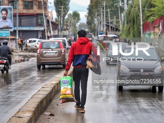 After the attack on Non-Local Workers in Kashmir's Kulgam, Rahul Kumar From Bihar with some blankets walks towards a High Security accommoda...