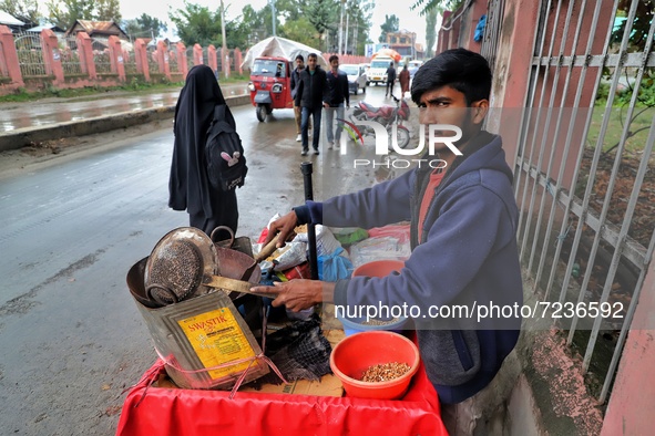 Rishik, 21, a Non-Local worker selling snacks outside a Shrine in Sopore, District Baramulla, Jammu and Kashmir, India on 18 October 2021. 2...