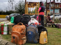 Non-Local Laborers wait outside a Railway Station with all their belongings in Sopore, District Baramulla, Jammu and Kashmir, India on 18 Oc...