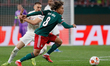 Alexis Beka Beka (R) of Lokomotiv Moscow and Berkan Kutlu of Galatasaray vie for the ball...