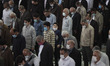 Iranian worshippers wearing protective face masks pray at the University of Tehran during...