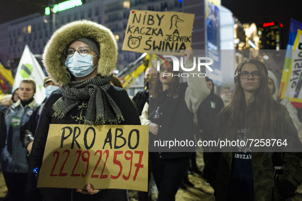People take part in a demonstration against the abortion ban, in Warsaw, Poland, on October 22, 2021.  