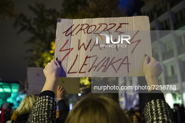 People take part in a demonstration against the abortion ban, in Warsaw, Poland, on October 22, 2021.  
