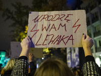 People take part in a demonstration against the abortion ban, in Warsaw, Poland, on October 22, 2021.  (