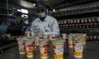 Palestinian workers work at the Hanover factory for the milk and dairy industries and its...