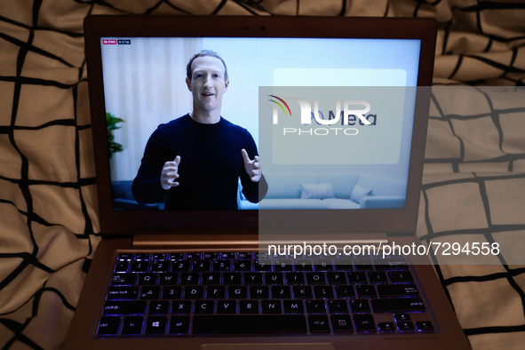 Mark Zuckerberg announcing the new name of the company and Meta logo are seen during Facebook Connect livestream displayed on a laptop scree...