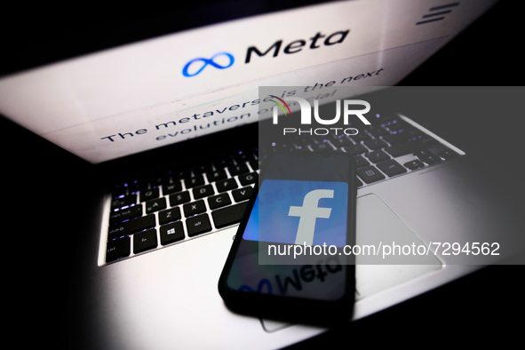 Meta website displayed on a laptop screen and Facebook app logo displayed on a phone screen are seen in this illustration photo taken in Kra...