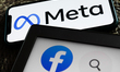 Meta logo displayed on a phone screen and Facebook icon displayed on a laptop screen are s...