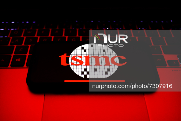 TSMC logo displayed on a phone screen and a laptop keyboard are seen in this illustration photo taken in Krakow, Poland on October 30, 2021....